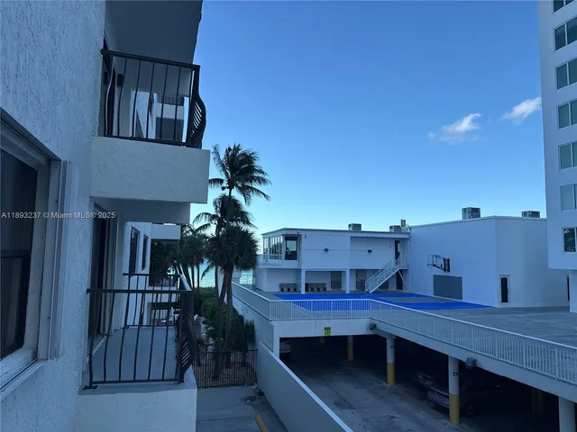 a view of a room with wooden flooring and potted plants