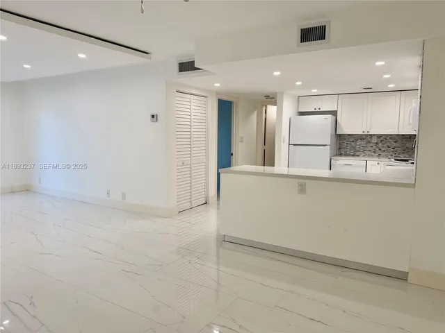 a view of a hallway to kitchen