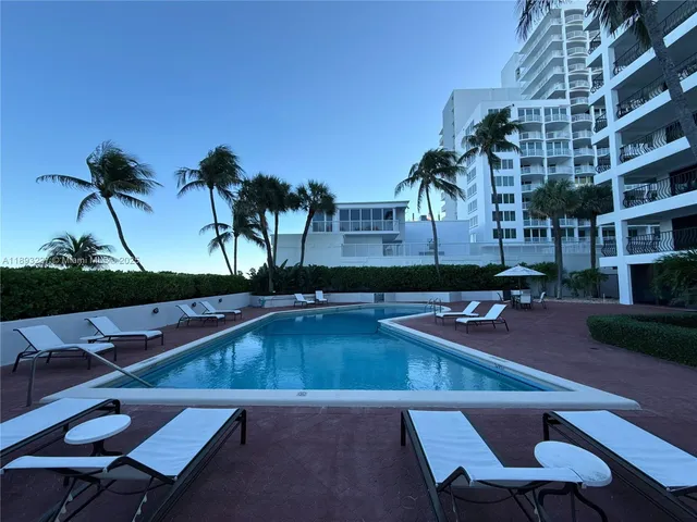 a swimming pool with outdoor seating and yard