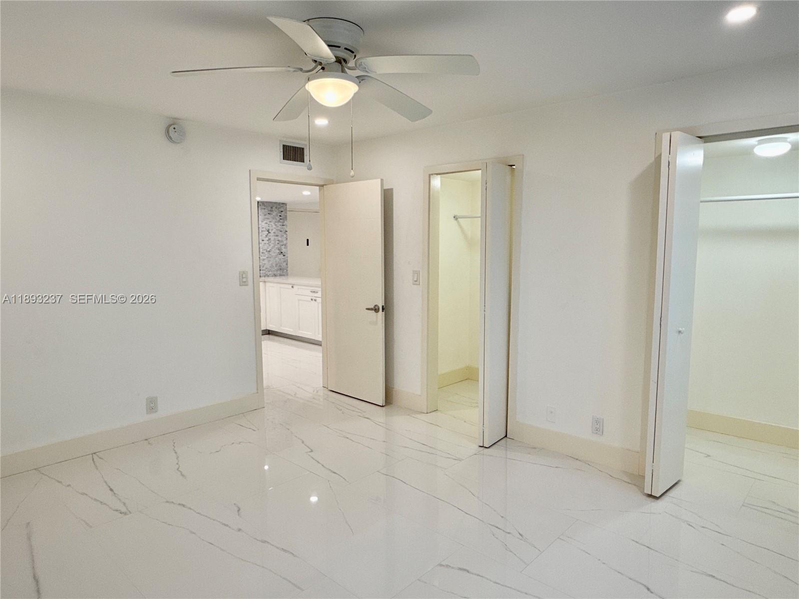 5415 Collins Avenue, Unit 304 Miami Beach, FL 33140 - Photo 7 of 20 a view of a livingroom with a ceiling fan & entryway