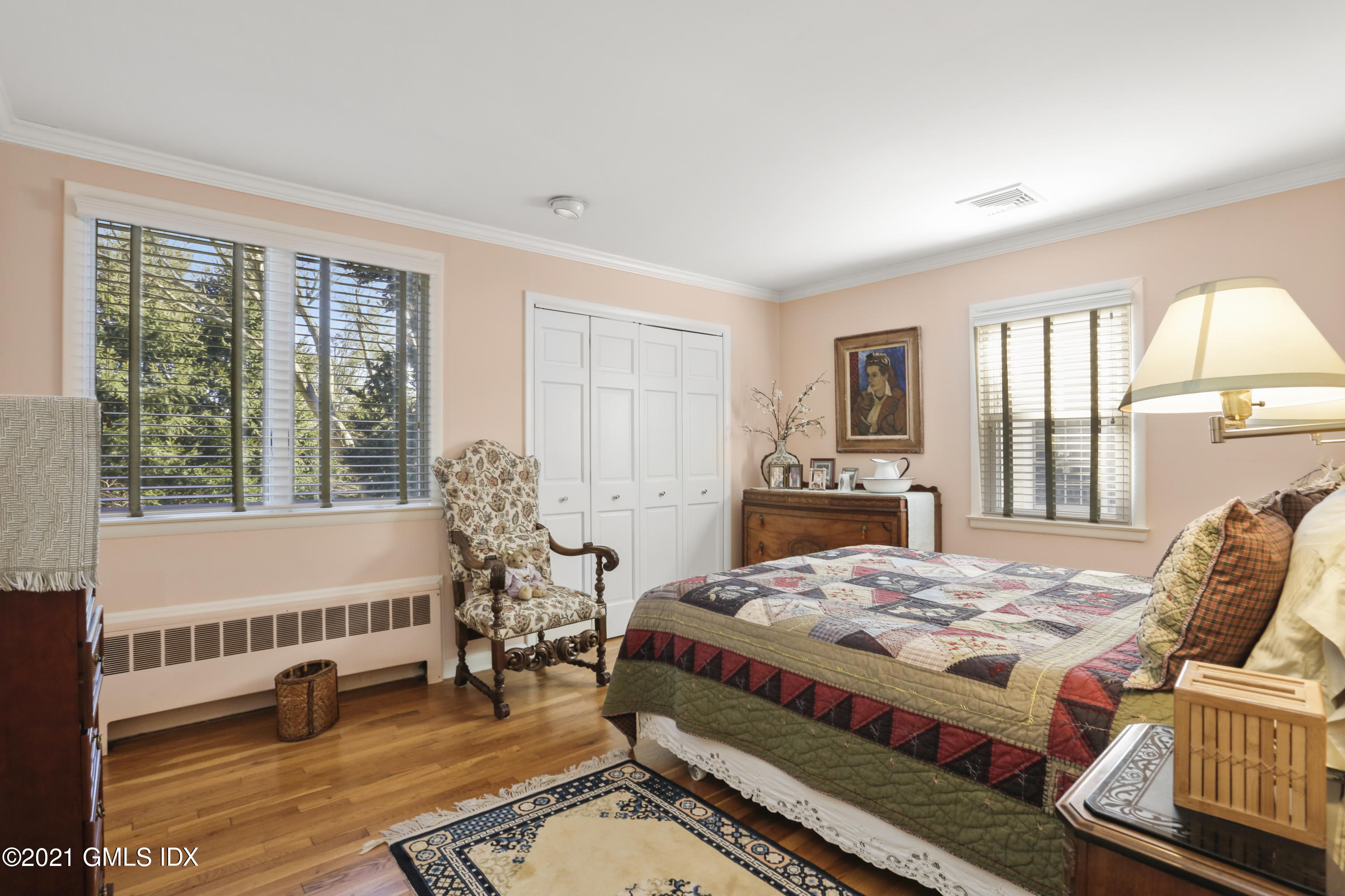 3 Old Wagon Road Old Greenwich, CT 06870 - Photo 11 of 37 a bedroom with a bed and large windows