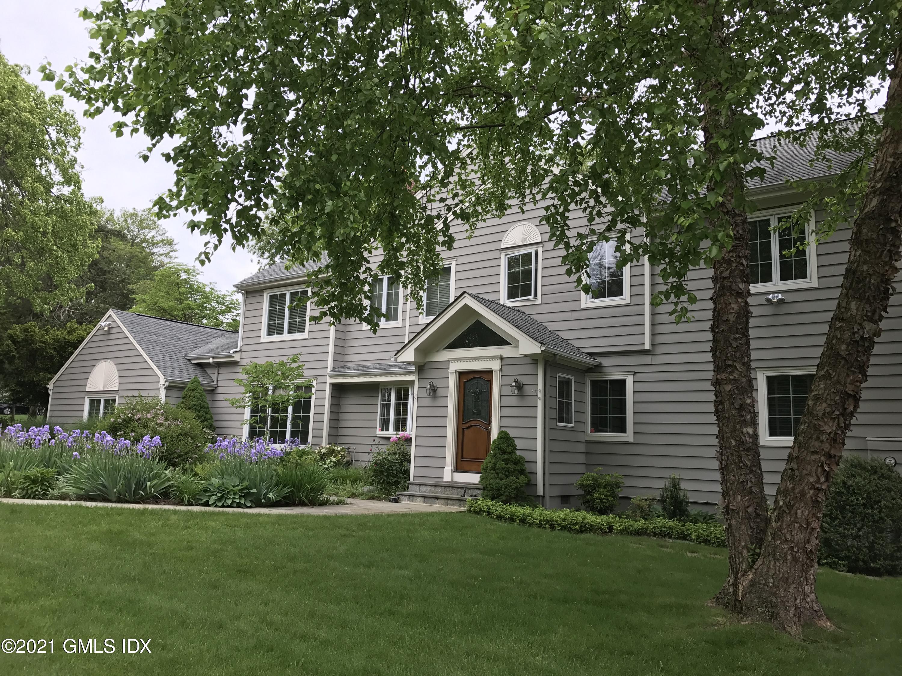 3 Old Wagon Road Old Greenwich, CT 06870 - Photo 25 of 37 a front view of a house with a garden