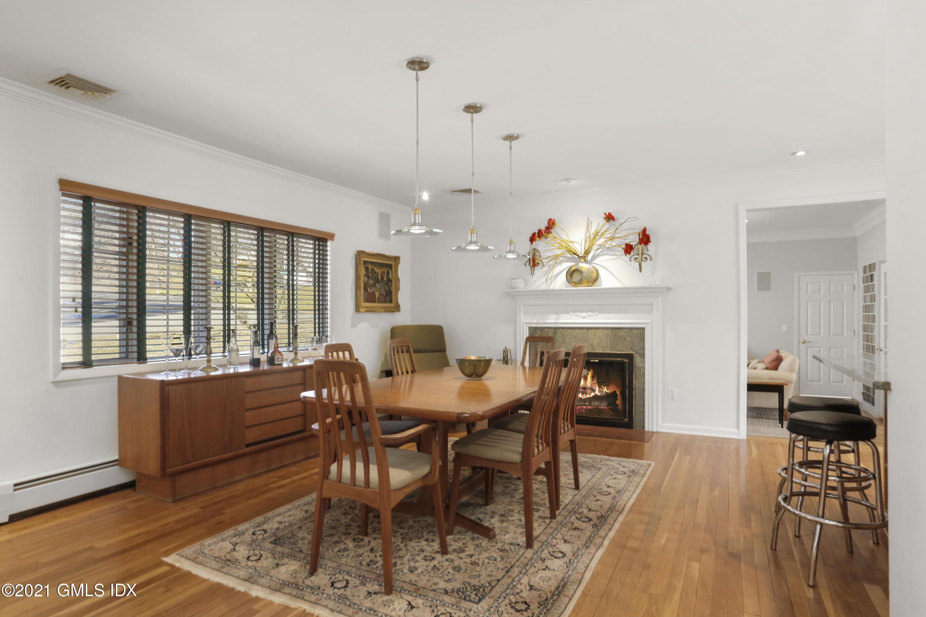 3 Old Wagon Road Old Greenwich, CT 06870 - Photo 4 of 37 a view of a dining room with furniture a fireplace and wooden floor