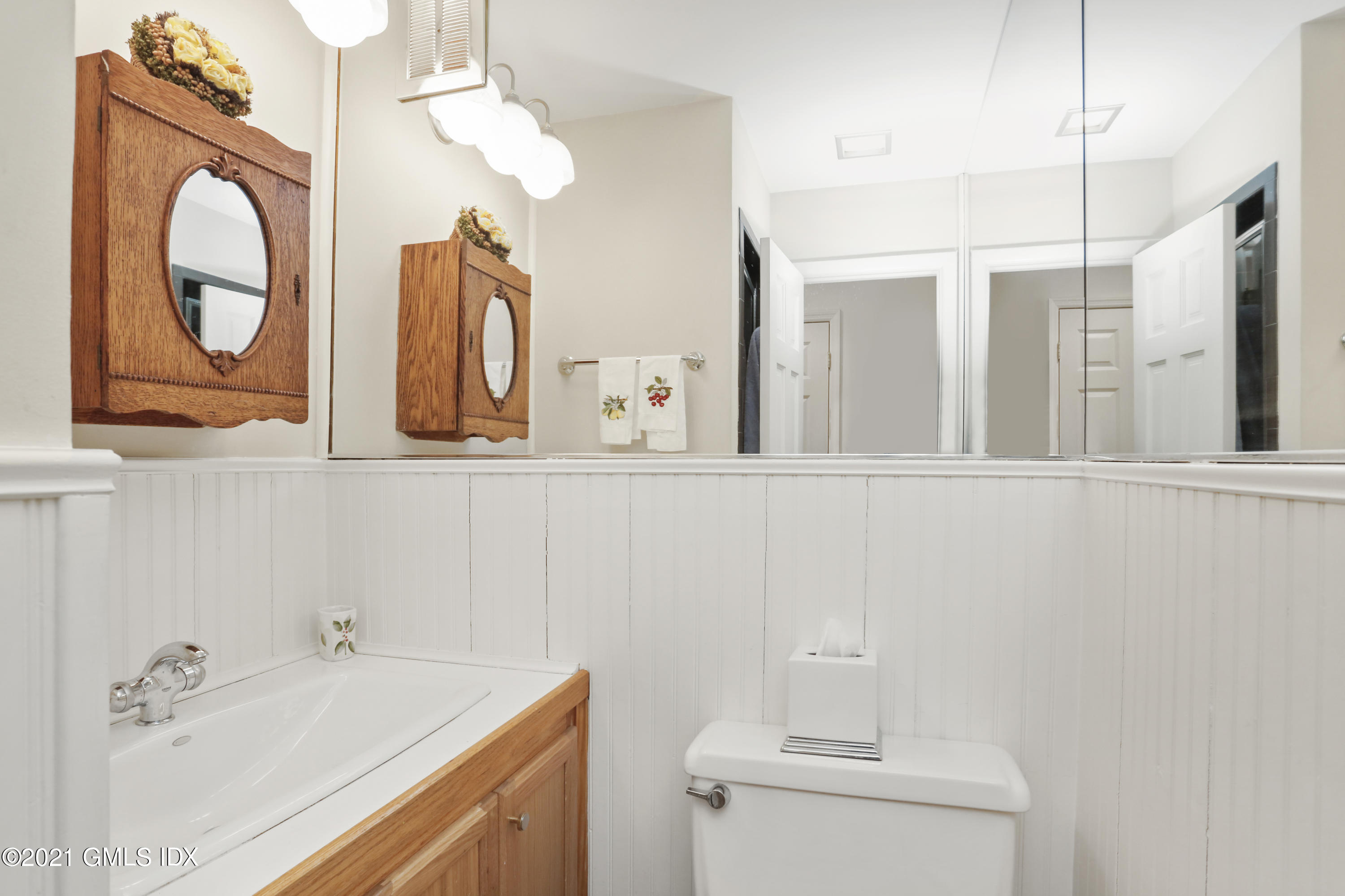 3 Old Wagon Road Old Greenwich, CT 06870 - Photo 10 of 37 a bathroom with a sink and a mirror