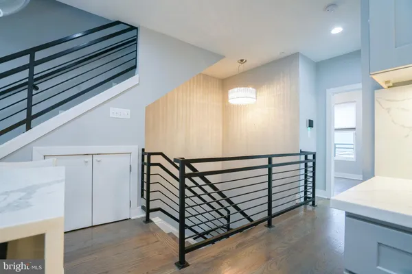 a view of a hallway with entryway wooden floor and front door