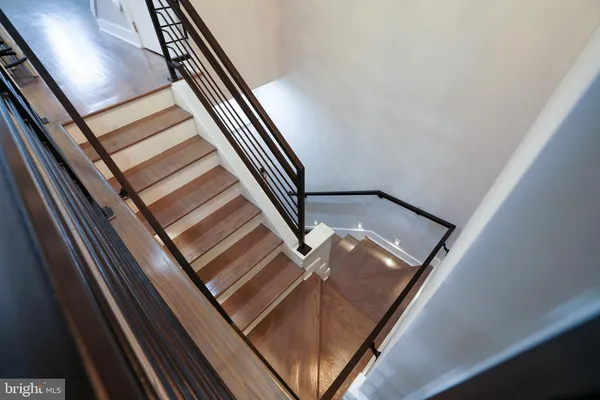 a open kitchen with stainless steel appliances kitchen island granite countertop a stove a sink and a wooden floors