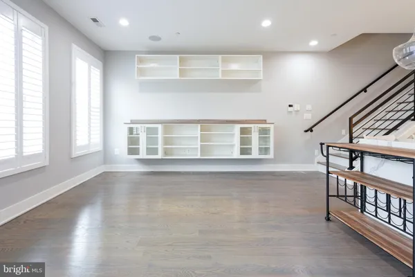 a view of a workspace with furniture and a window
