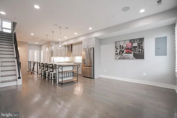 a kitchen with kitchen island white cabinets and stainless steel appliances