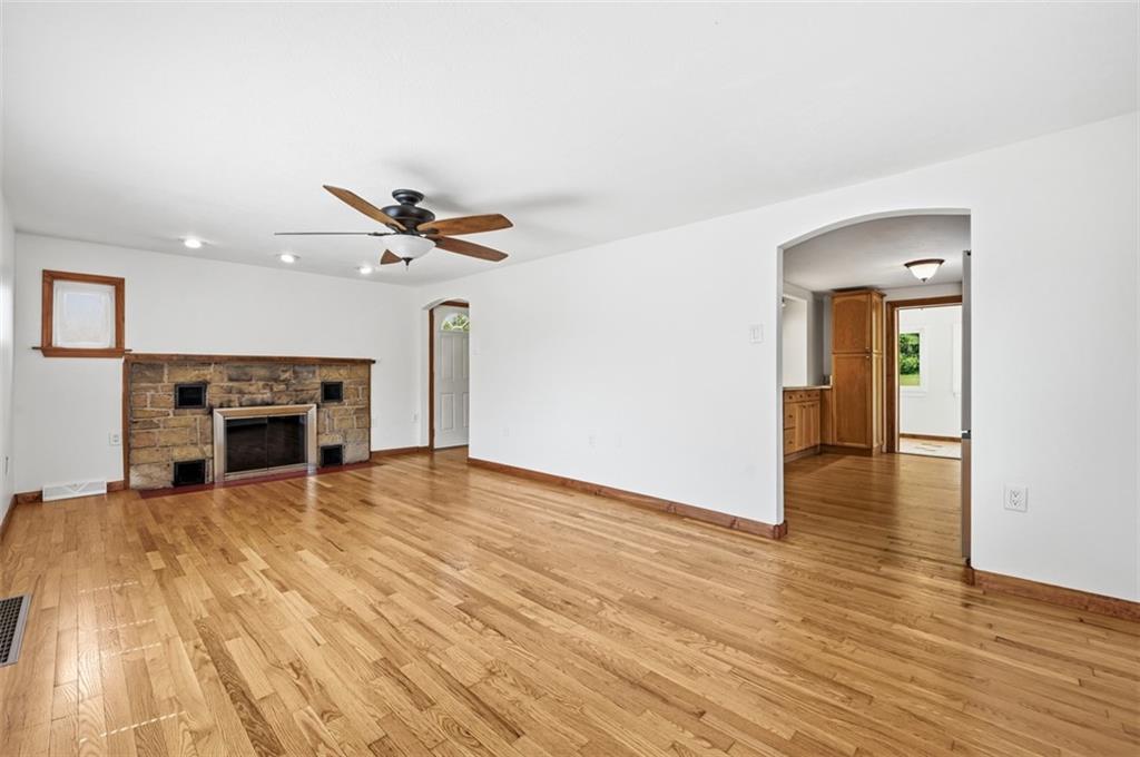 123 Cemetery Road Slippery Rock, PA 16057 - Photo 6 of 33 The spacious living room showcases beautiful hardwood floors and a striking stone gas fireplace, creating a warm and inviting focal point. With its open layout, this space is perfect for a living room/dining room concept. If you don't use a dining room then you have a extra large space for your living room.