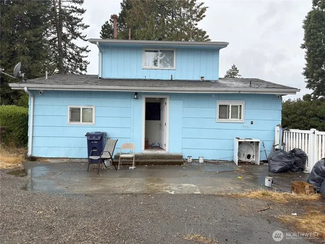 a view of a house with a yard and sitting area