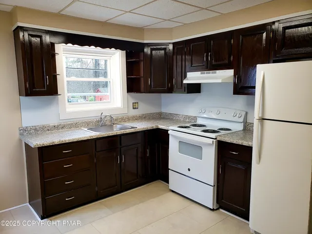 a kitchen with a sink and a refrigerator