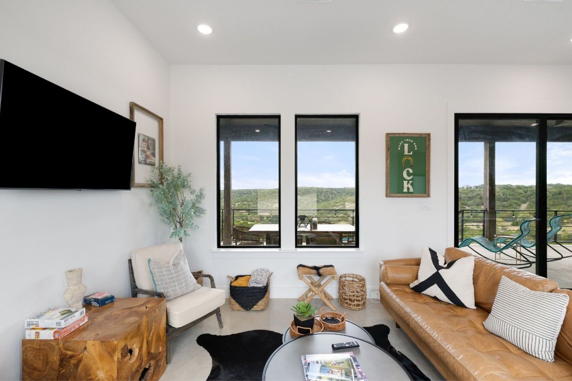 11 Sacramento Boerne, TX 78006 - Photo 19 of 40 Living area with healthy amount of natural light, recessed lighting, and concrete floors