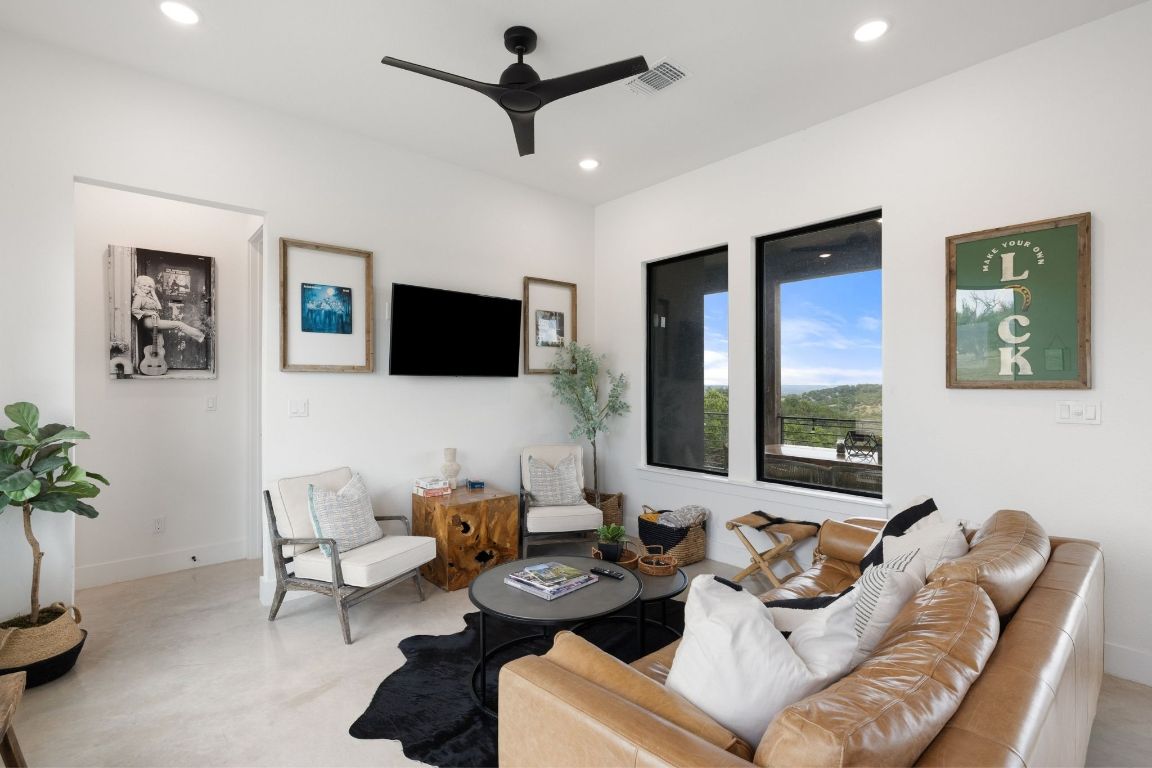 11 Sacramento Boerne, TX 78006 - Photo 20 of 40 Living room featuring a ceiling fan, recessed lighting, and finished concrete flooring