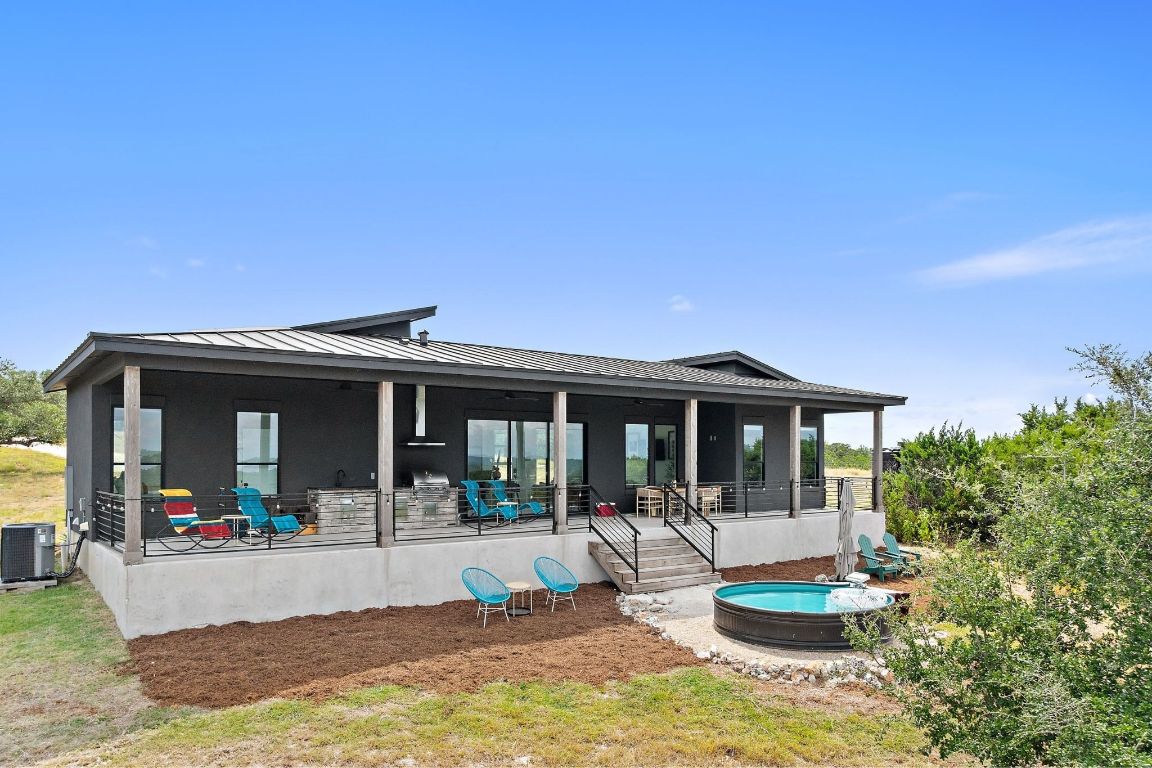 11 Sacramento Boerne, TX 78006 - Photo 32 of 40 Rear view of house with a standing seam roof, a metal roof, and a porch