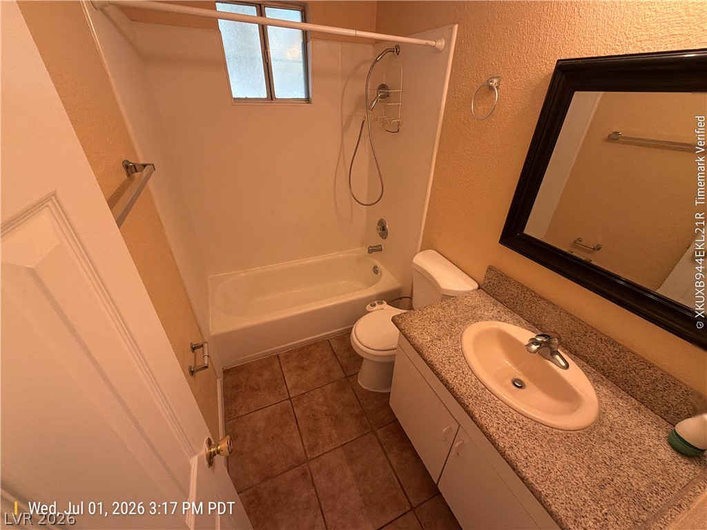 2313 Ragland Street Las Vegas, NV 89108 - Photo 7 of 11 A compact bath features a combined shower and tub, complete with a window for natural light.
