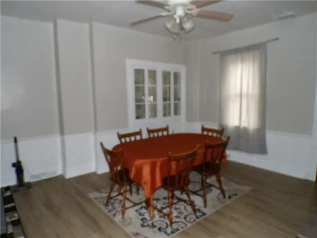 a view of a dining room with furniture and window