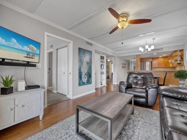 a living room with furniture and wooden floor