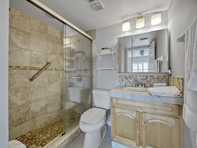 a bathroom with a sink toilet and shower