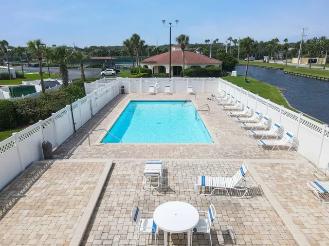 a view of a patio with a table and chairs