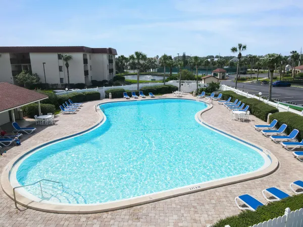 a view of a swimming pool with a yard