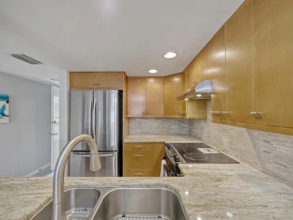 a kitchen with stainless steel appliances granite countertop a sink and a granite counter tops