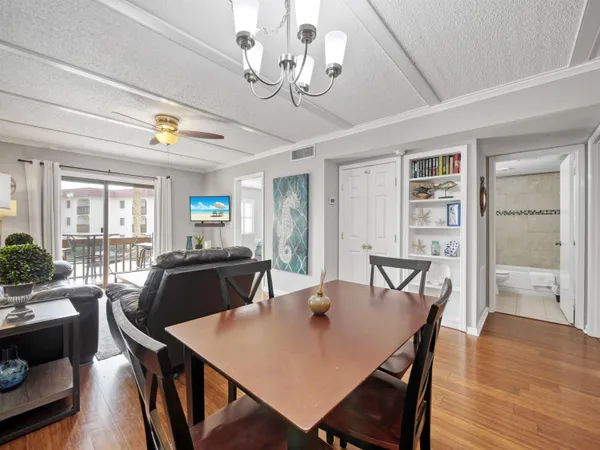a view of a dining room with furniture and wooden floor