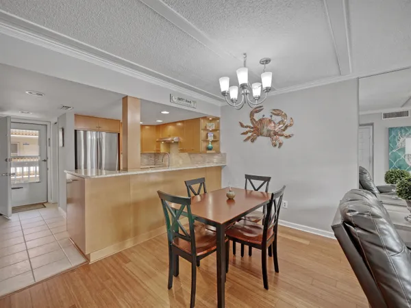 a view of a dining room with furniture and chandelier