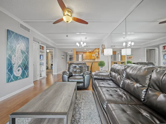 a living room with furniture and a chandelier