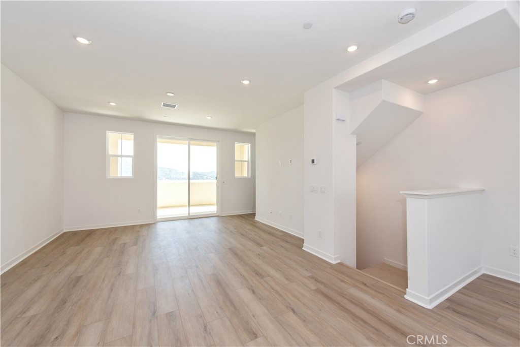 211 Ruby Road Rancho Mission Viejo, CA 92694 - Photo 19 of 41 a view of an empty room with wooden floor and windows
