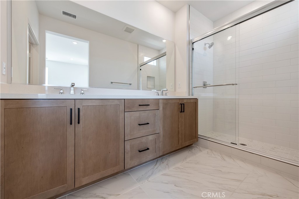 211 Ruby Road Rancho Mission Viejo, CA 92694 - Photo 30 of 41 a bathroom with a granite countertop sink mirror and cabinets