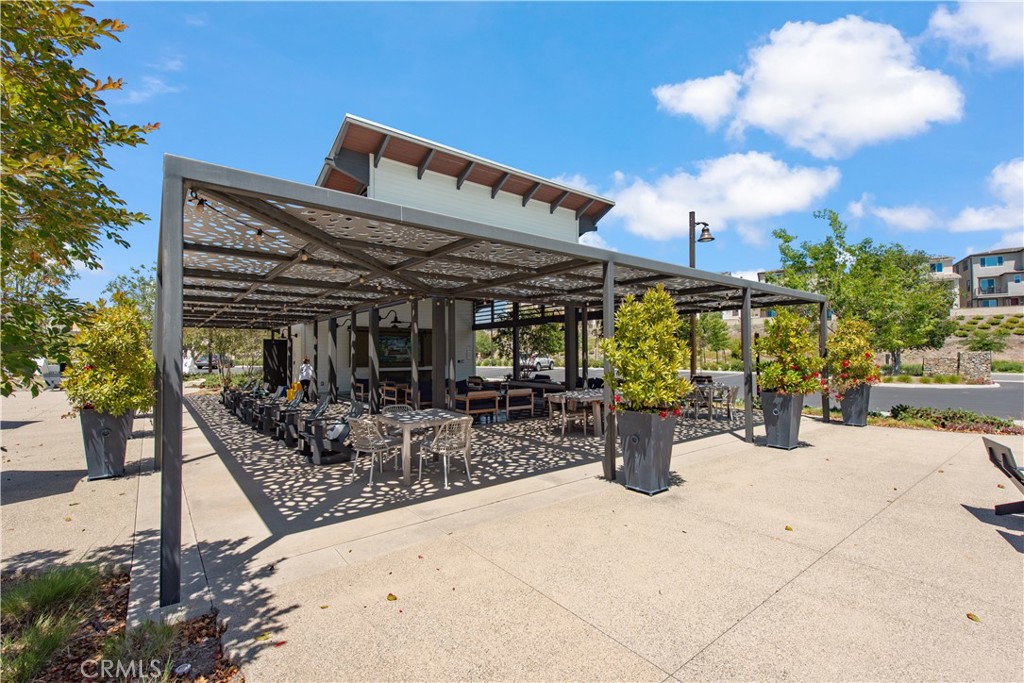 211 Ruby Road Rancho Mission Viejo, CA 92694 - Photo 39 of 41 a view of a patio with dining table and chairs and potted plants