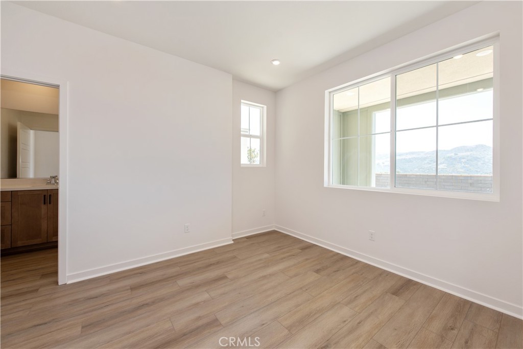 211 Ruby Road Rancho Mission Viejo, CA 92694 - Photo 8 of 41 an empty room with wooden floor and windows