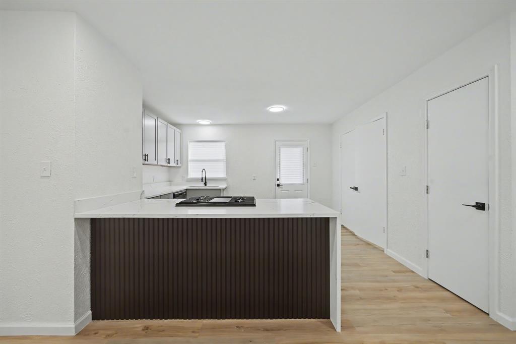 11446 Lippitt Avenue Dallas, TX 75218 - Photo 6 of 26 a view of kitchen with stainless steel appliances granite countertop a sink and cabinets
