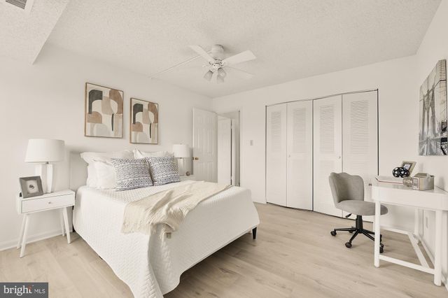 a bedroom with a bed and a chair