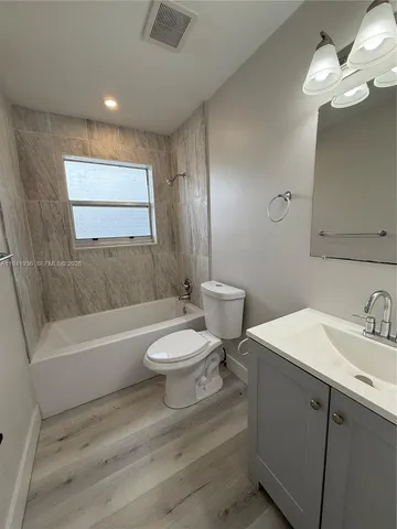 a bathroom with a sink a toilet and bathtub