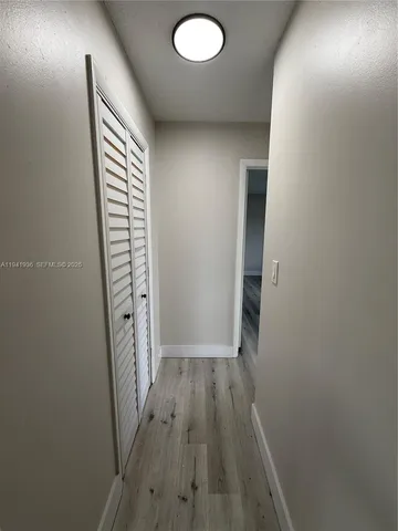 wooden floor in a room next to a window