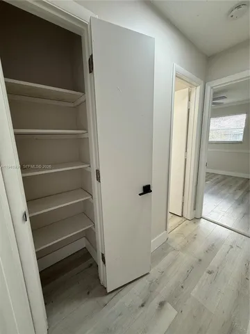 a view of walk in closet with empty racks