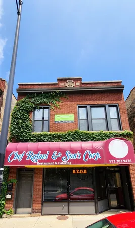 a street sign on the side of building
