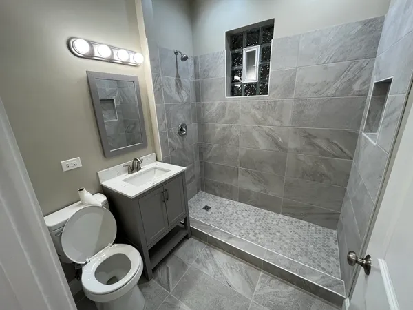 a bathroom with a sink toilet and shower