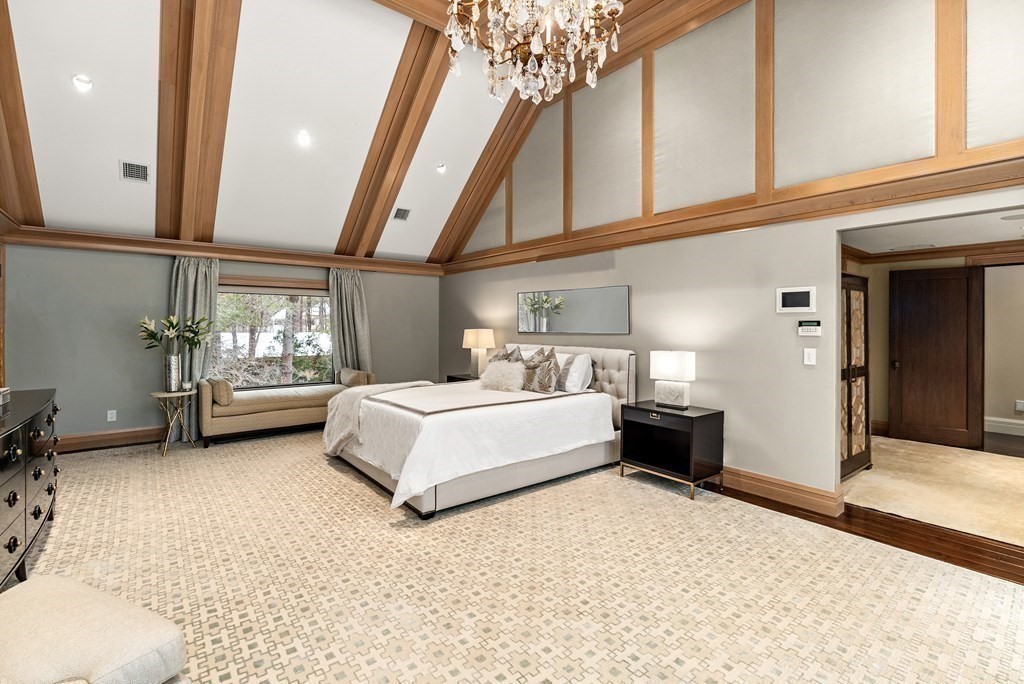 51 Scotch Pine Road Wellesley, MA 02481 - Photo 17 of 30 a spacious bedroom with a bed and a chandelier