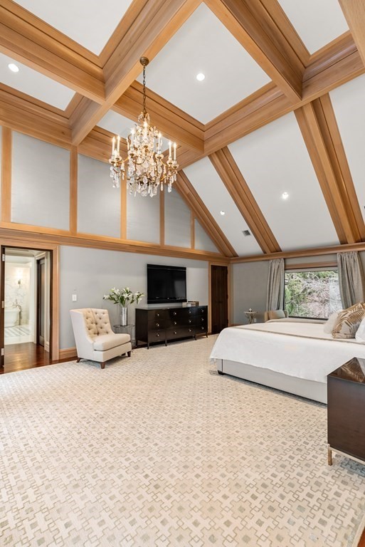 51 Scotch Pine Road Wellesley, MA 02481 - Photo 18 of 30 a large room with a large bed and a chandelier