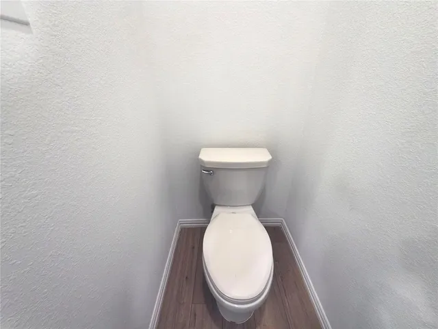 a close view of a toilet in a small room