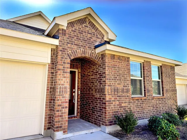a front view of a house with large windows