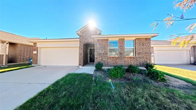a kitchen with stainless steel appliances a stove a sink and a refrigerator