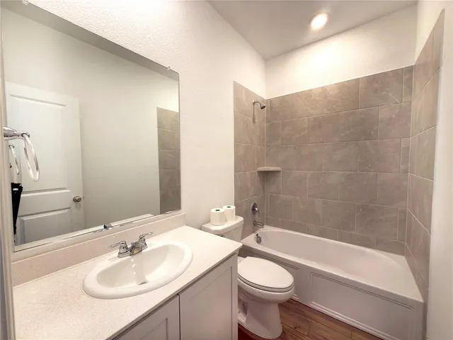 a bathroom with a sink a toilet and bathtub