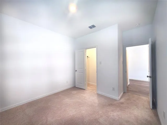 an empty room with closet area