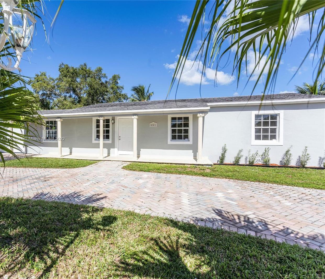 551 East 39th Street Hialeah, FL 33013 - Photo 2 of 8 a view of house with backyard and trees