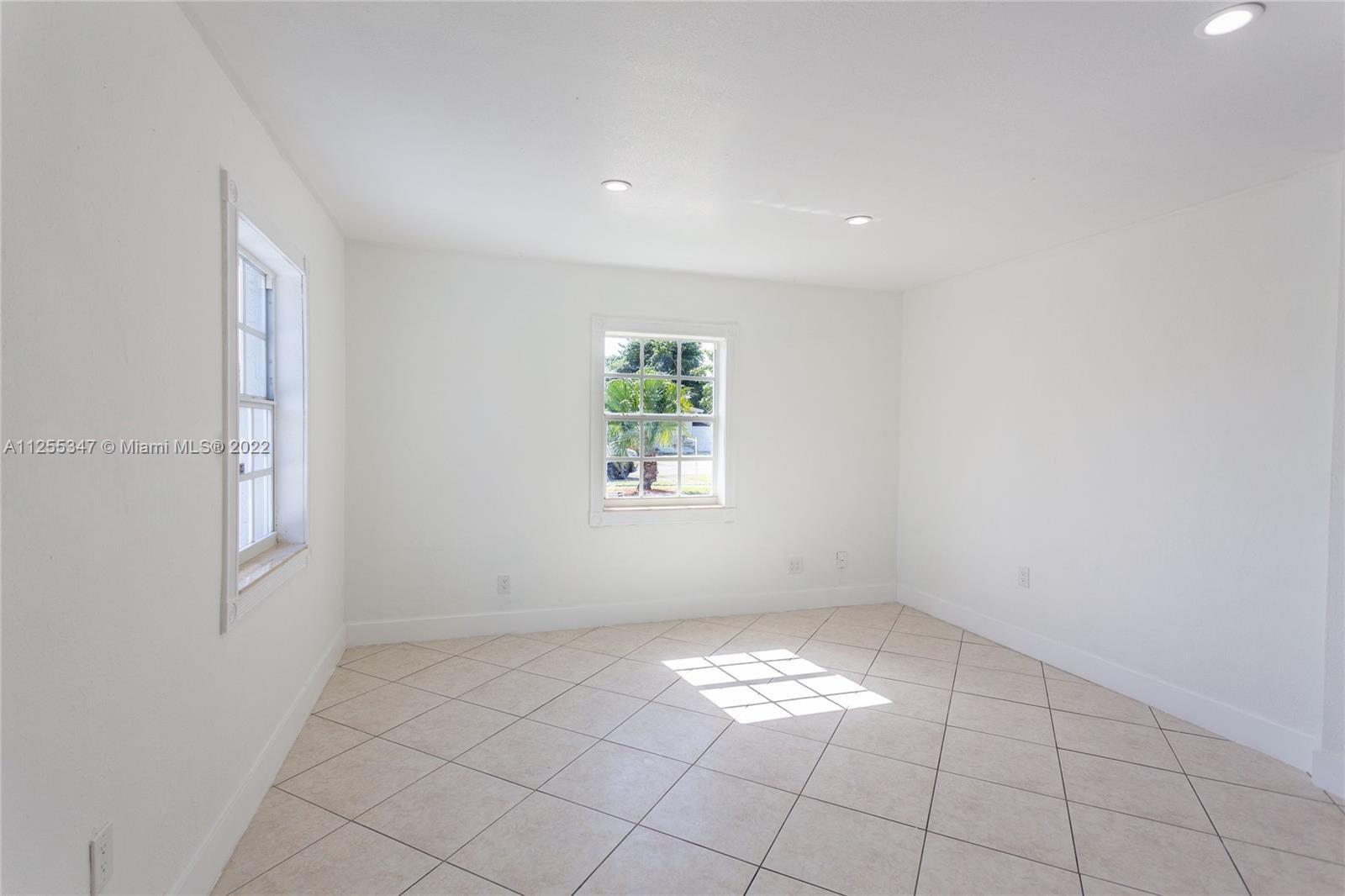 551 East 39th Street Hialeah, FL 33013 - Photo 6 of 8 an empty room with windows