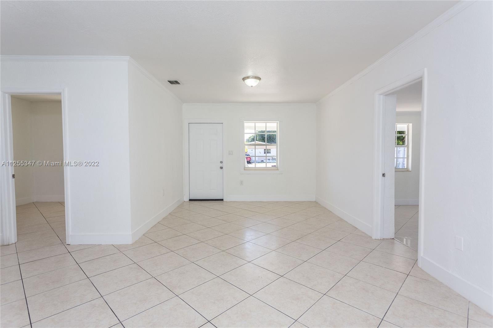 551 East 39th Street Hialeah, FL 33013 - Photo 8 of 8 an empty room with white walls and windows