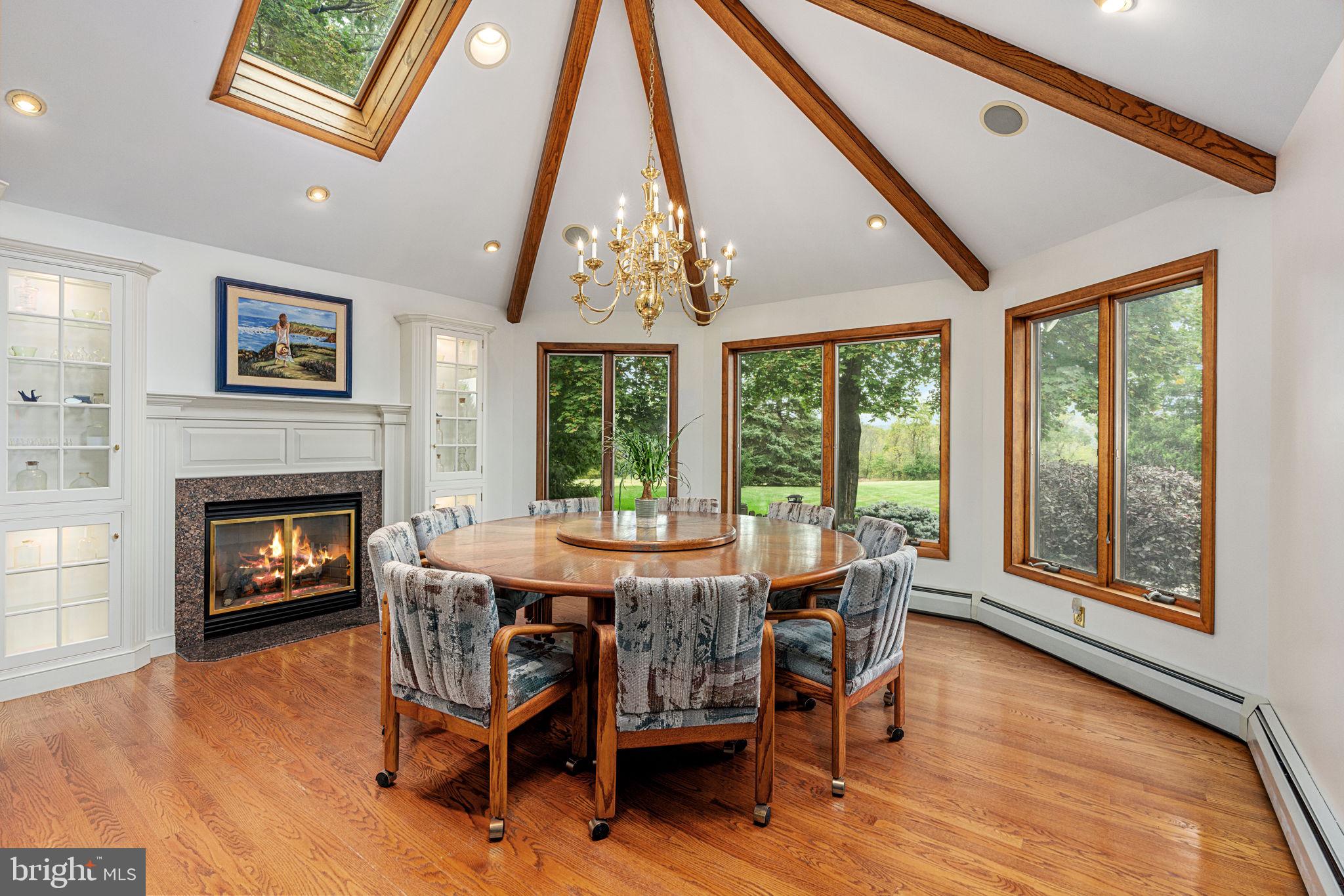 1995 Peppermint Road Coopersburg, PA 18036 - Photo 13 of 67 a dining room with furniture a fireplace and wooden floor